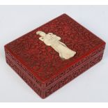 A 19th century Chinese cinnabar lacquer box and cover with four compartments.