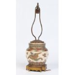 A Japanese Satsuma jar converted to a tablelamp with gilt metal mounts.