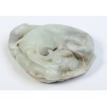 A Chinese celadon jade carving of a carp with a ruyi branch and decorated with a leaf to the back