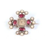 A Georgian yellow metal mourning brooch of Maltese cross form set with pearls and garnets and with