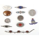 Ten silver brooches and a necklace.
