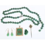 A collection of Chinese 20th century spinach jade and yellow metal jewellery.