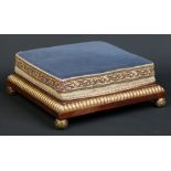 A Victorian mahogany and parcel gilt upholstered foot stool raised on ormolu ball feet, 43cm square.