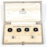 A cased set of 18 carat gold and platinum studs by Asprey. Set with pearls on onyx grounds.