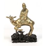 A 19th century Chinese bronze figure of Shou Lao riding upon a deer,