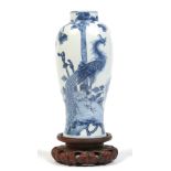 A 19th century Chinese baluster jar on carved hardwood plinth.