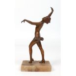 An Art Deco gilt spelter figure of a dancing girl dressed only in a ra ra skirt and raised on an
