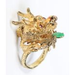 A large Chinese 14 carat gold planished ring formed as a dragons head.