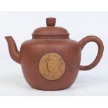 A 20th century Chinese Yixing teapot with a sprigged relief portrait of Mao Zedong.