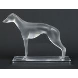 A Lalique 1960s frosted glass model of a greyhound raised on a rectangular clear glass plinth.