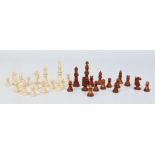 A carved and turned ivory chess set with one side stained brown. King pieces 7.5cm.