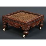 An Anglo Indian carved hardwood bergere footstool.