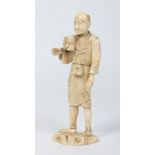 A Japanese Meiji period carved ivory sectional Okimono formed as a man with a double gourd flask