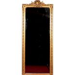 A large 19th century gilt wood and gesso pier mirror with wreath moulded pediment, 258cm x 110cm.