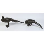 A pair of Japanese Meiji period patinated bronze naturalistic models of a peacock and hen.