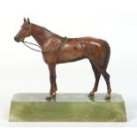 An early 20th century cold painted bronze study of a racehorse raised on a tapering onyx plinth.