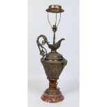 A gilt metal tablelamp formed as a Romanesque ewer and raised on a marble plinth,