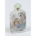 A Chinese carved rock crystal snuff bottle with celadon jade top.