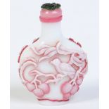 A Chinese carved cameo glass snuff bottle in opaque white and cranberry glass.