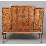 A Queen Anne style figured walnut cocktail cabinet.