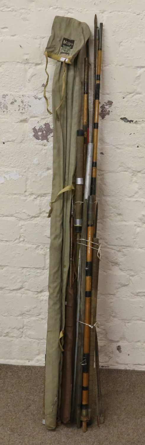 A collection of old split cane and fibreglass fishing rods and bank sticks to include Milbro