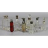 A collection of eight silver collared perfume and cruet bottles to include a ruby hexagonal double