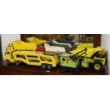 Two tinplate Tonka toy dumper trucks and one other along with a Tonka car carrier and a mechanical