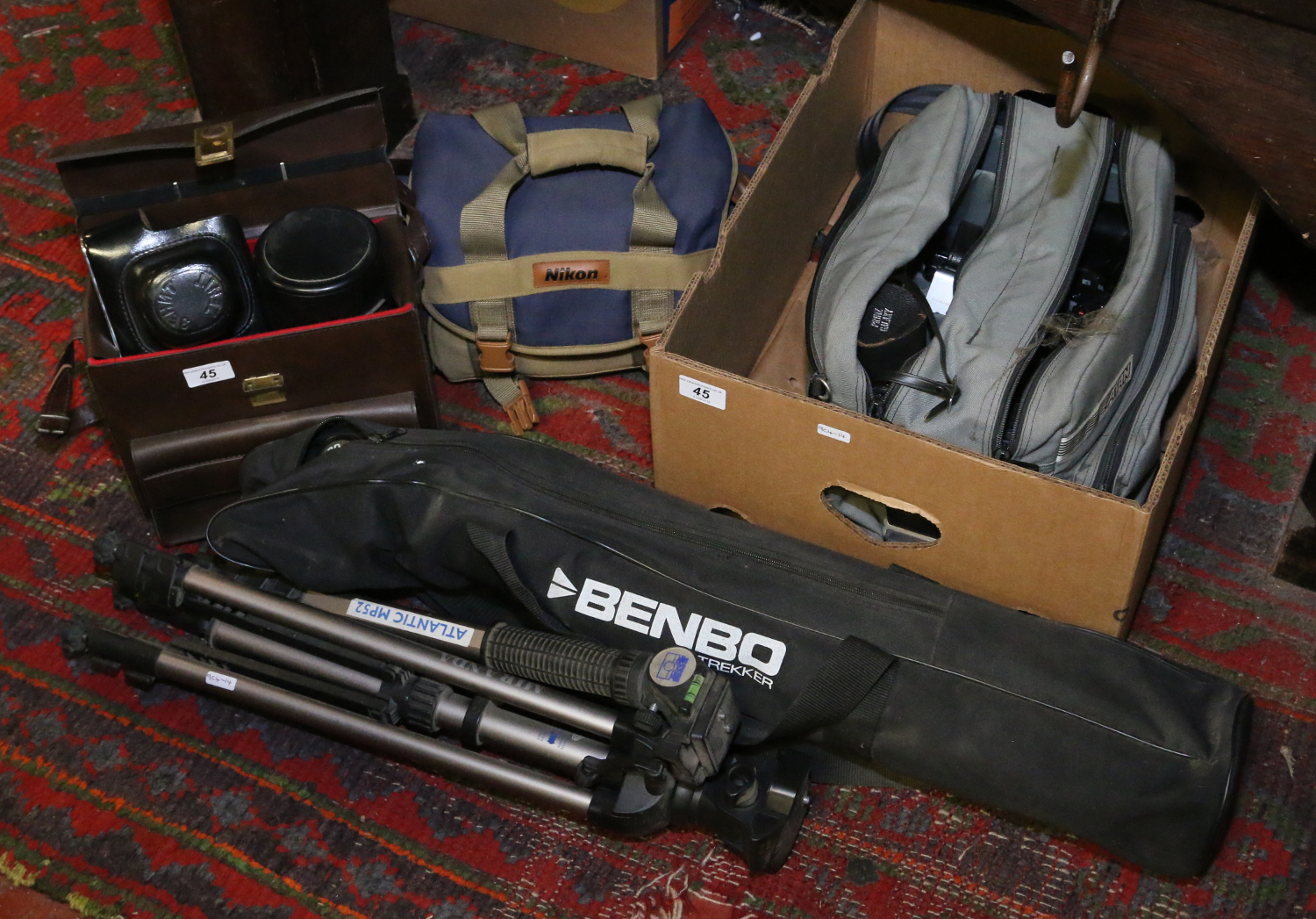 A collection of photographic equipment including cased cameras and tripods, etc.