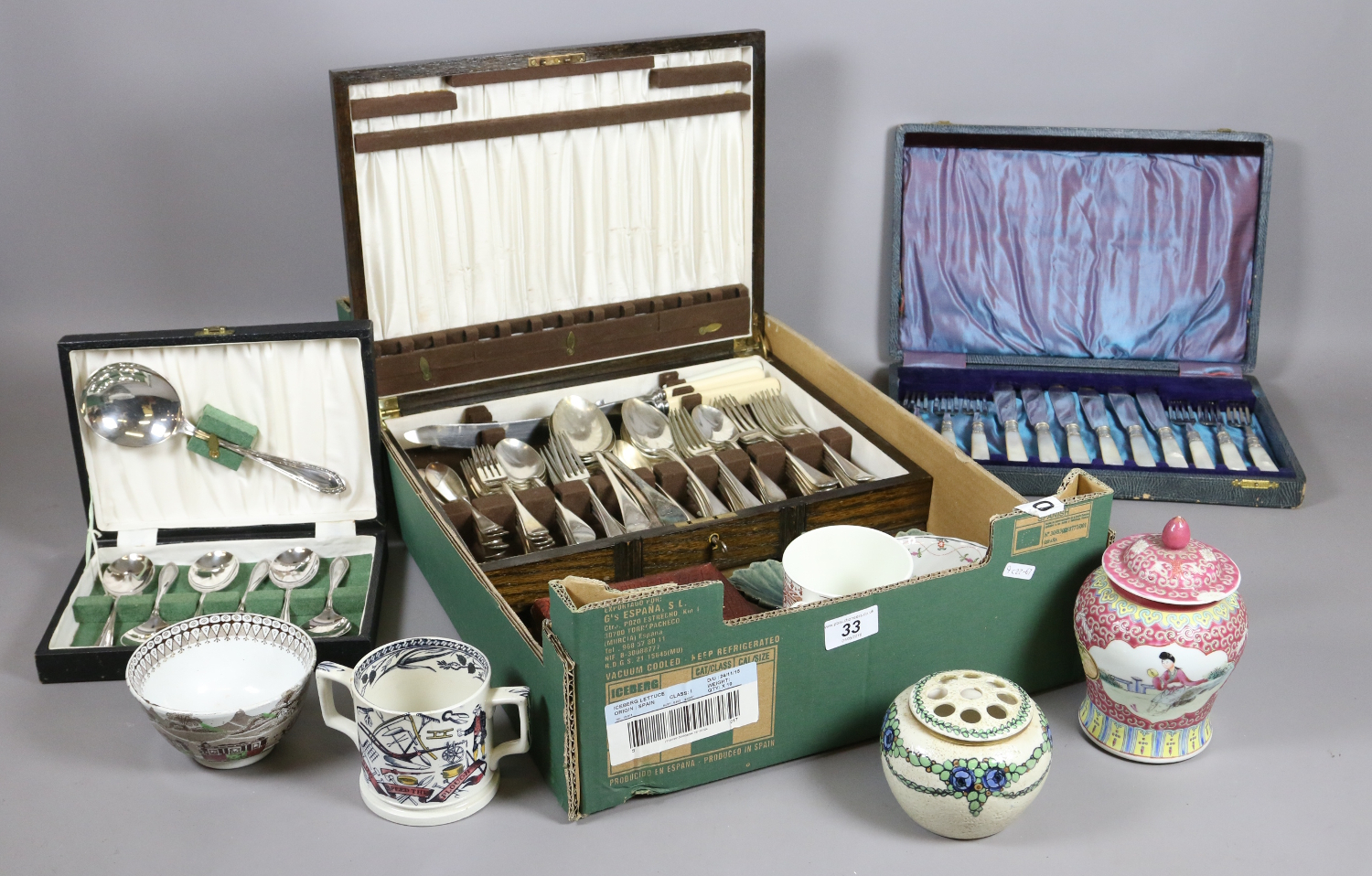 A box of ceramics and cased cutlery to include canteen sets, etc.