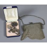 A ladies silver plate mesh evening bag and a silver locket brooch in the form of a Viking axe etc.