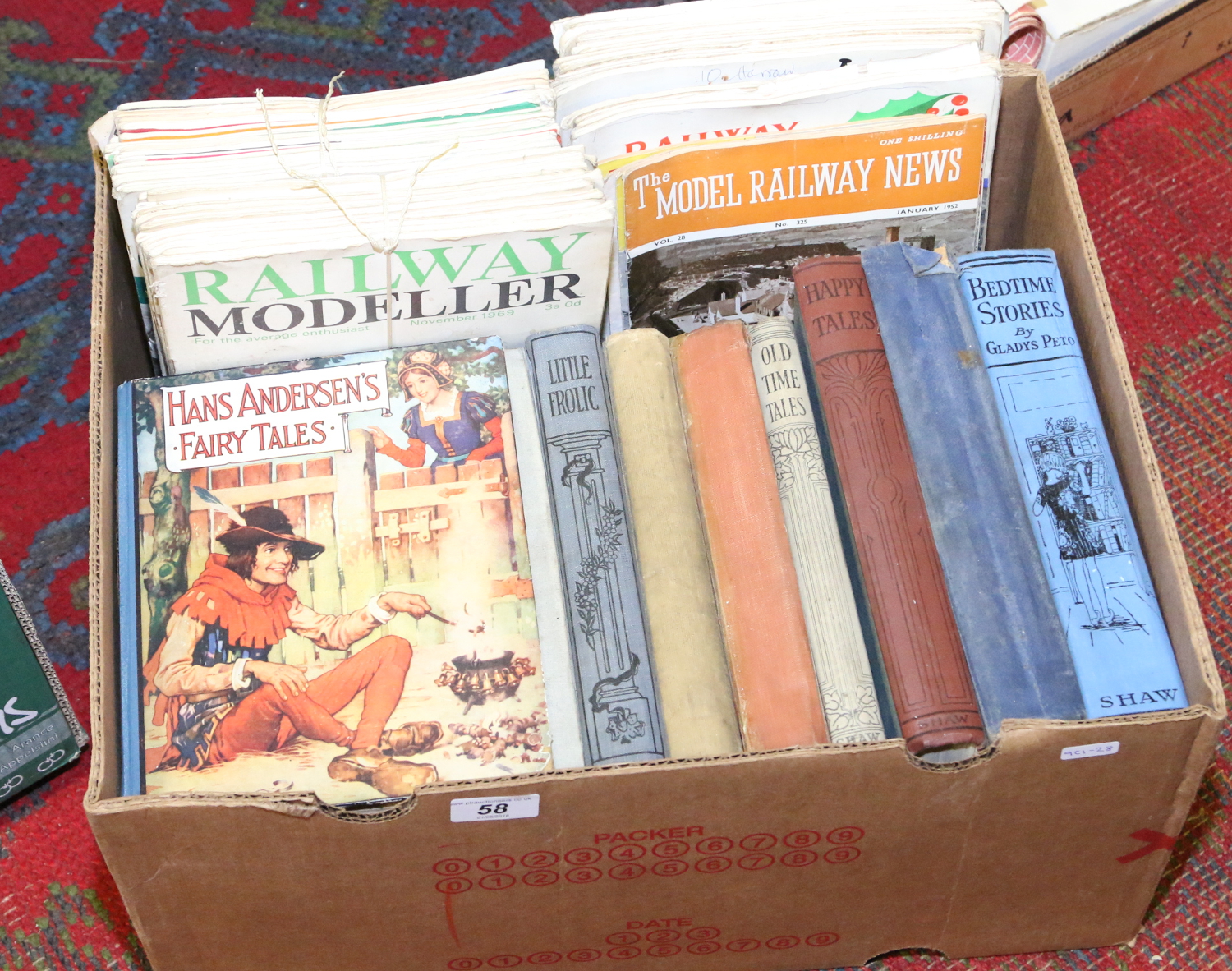 A collection of old hardback childrens books along with a collection of model railway magazines.
