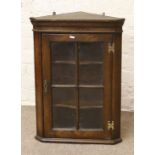 A Titchmarsh & Goodwin style carved oak wall mounted corner display cupboard.