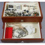 A jewellery box and contents of costume jewellery including beads,