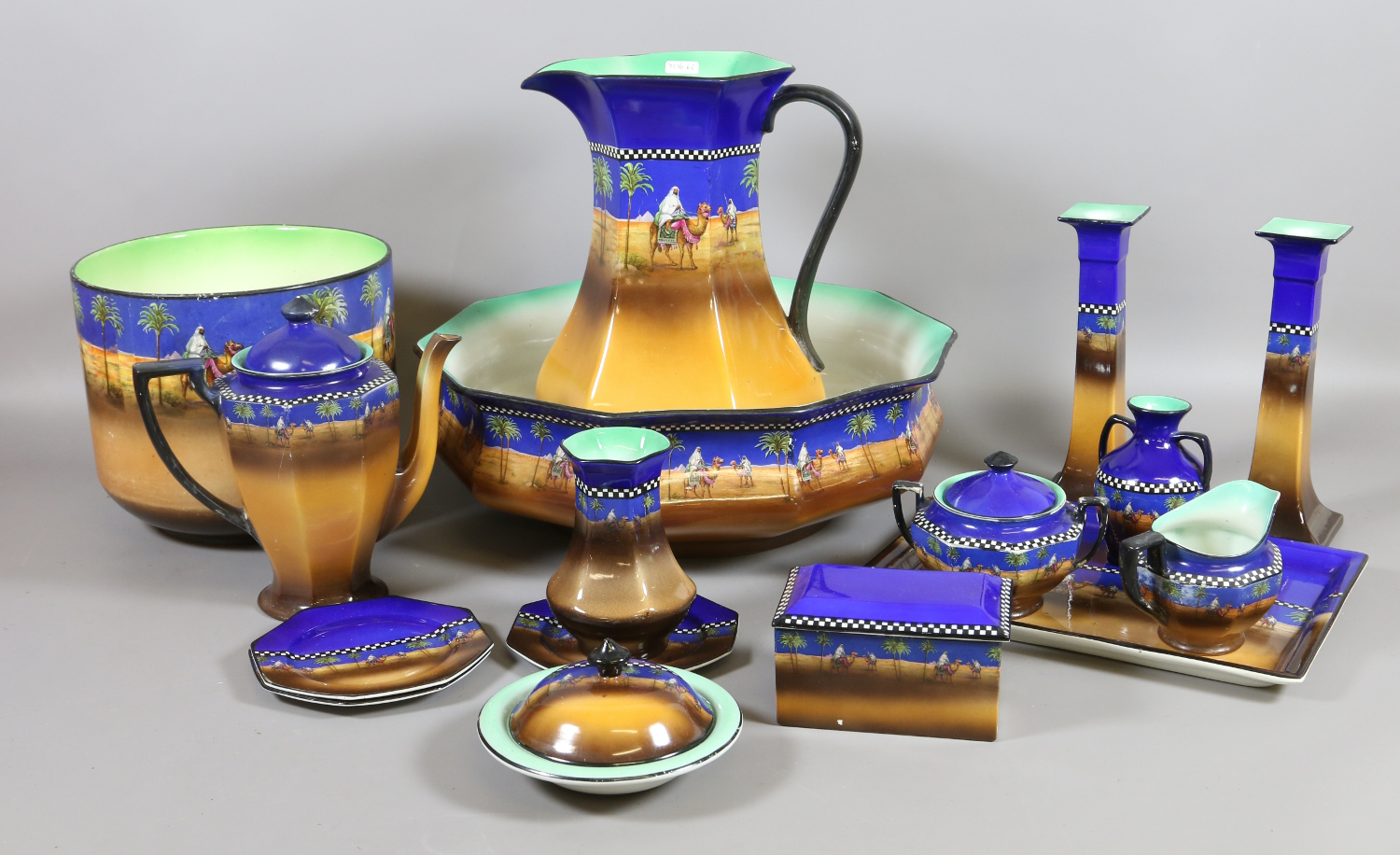 Fourteen pieces of Tunstall ceramics decorated with desert and Arab scenes to include jug and bowl,