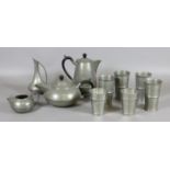 A three part Sheffield pewter tea service along with six goblets and a vinegar jug.