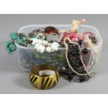 A tub and contents of costume jewellery to include bangles, bracelets, necklaces, etc.