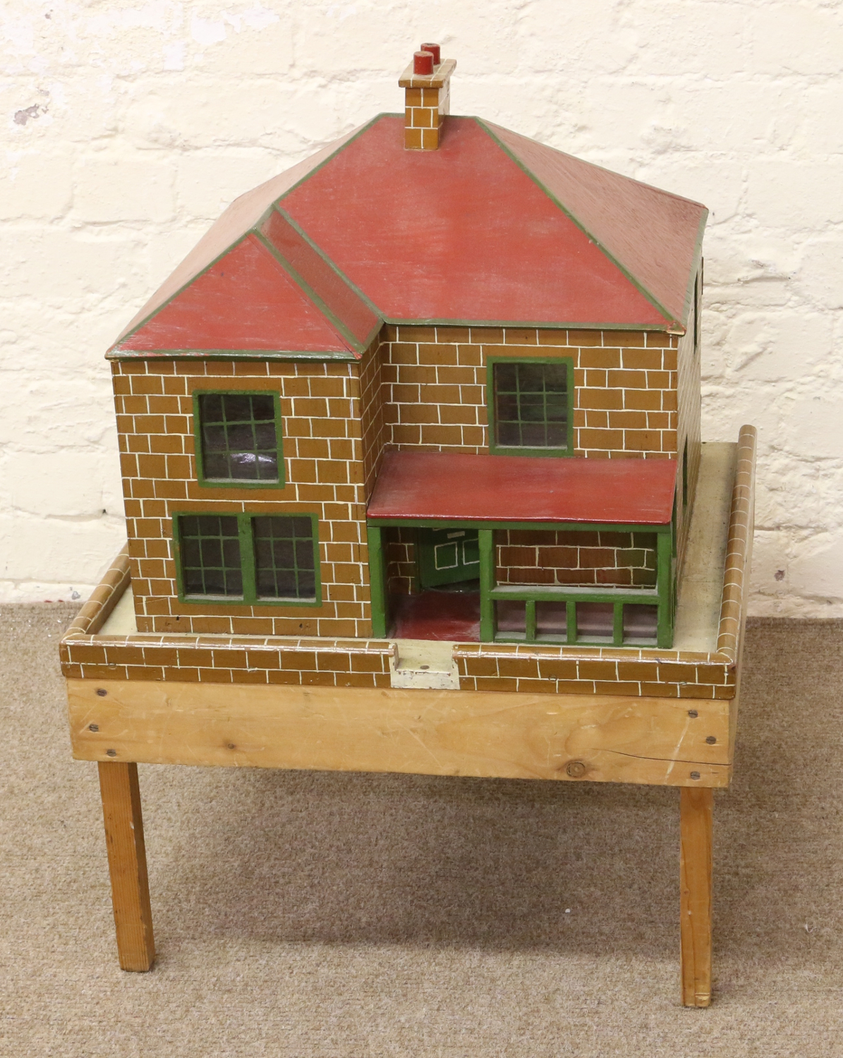 A vintage painted wooden dolls house and contents of miniature furniture.