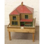 A vintage painted wooden dolls house and contents of miniature furniture.