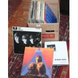 A collection of LP records to include rock, pop, Prince and a Beatles book.