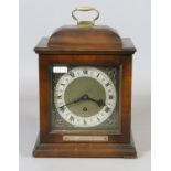 A mahogany cased presentation bracket clock with brass and silvered dial and Roman numeral markers