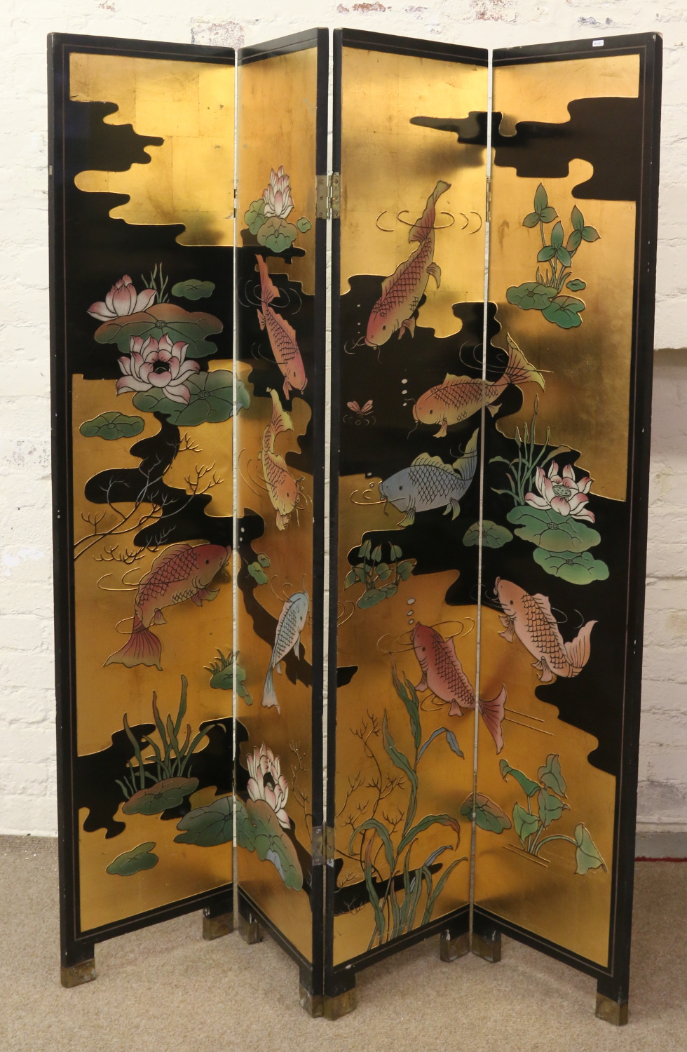 An oriental decorated four fold dressing screen with Chinese coy carp and lilly pads on ebonized