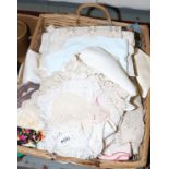 A basket and contents of various lace, linen and other materials.