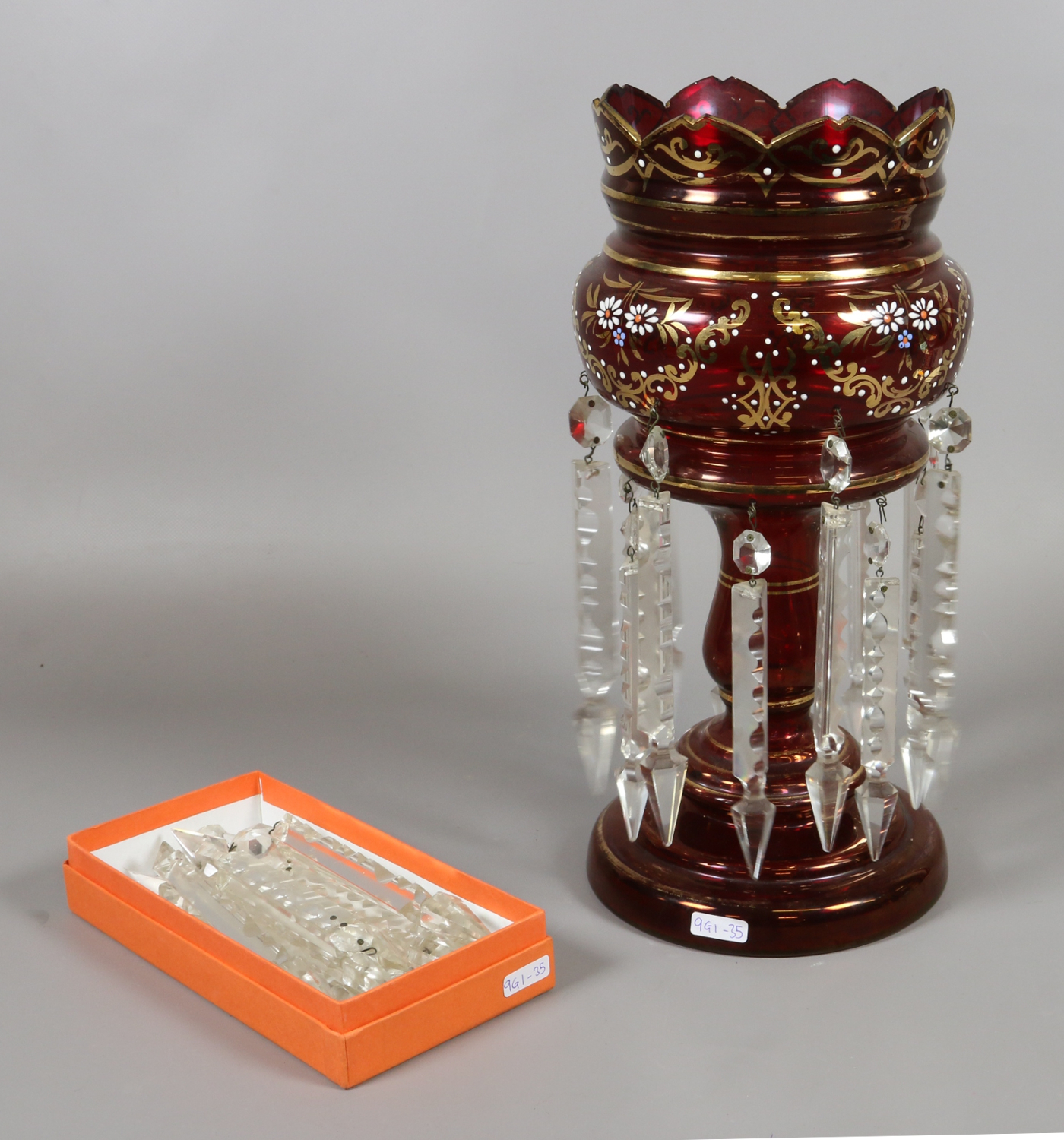 An early 20th century ruby glass lustre with gilt and enamel decoration.