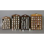 Four display racks of collectable thimbles.