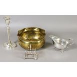 A silver plated candlestick, sauceboat and small toast rack, along with a planished brass planter.