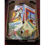 A box of vintage annuals including Rupert, Blue Peter and Eastenders.