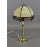 A brass effect tablelamp with segmented and jewelled shade.