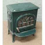 A cast iron green enamelled gas fire in the form of a log burner, made in England.