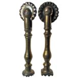 Two similar copper alloy pastry prints/jiggers, each with a cutting wheel and baluster stem, one
