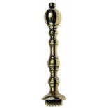 A good George III brass pastry print with ovoid finial, baluster stem and circular foot with